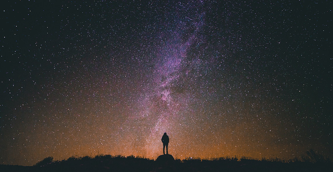 silhouette looking at universe