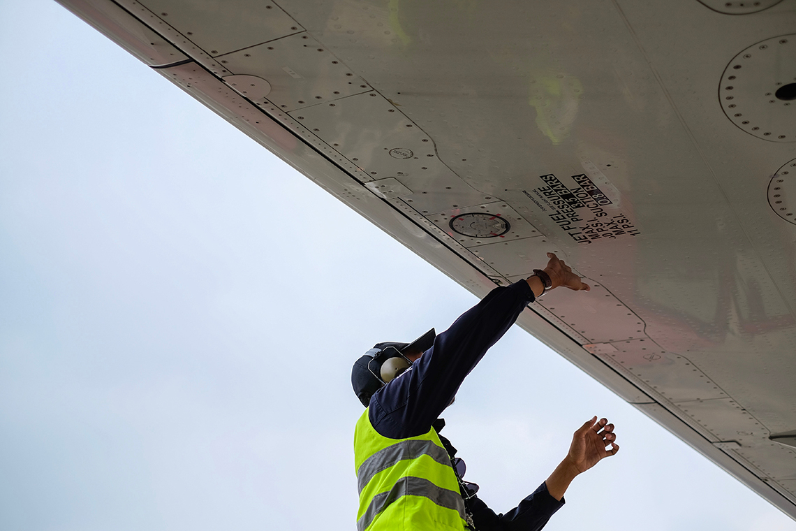 man maintaining an aeroplane