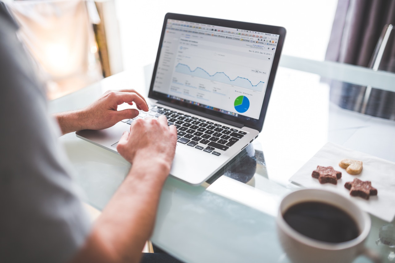 man using google analytics on laptop